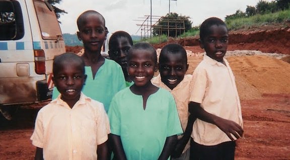 Danson and children in Uganda